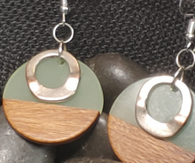 Load and play video in Gallery viewer, handmade Aromatherapy earrings. Circle shape. Top have light green acrylic. Lower have wood. smaller Silver colored floating circular embellishment layered on top.